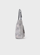 Gray lace-patterned handbag on a light gray background