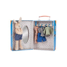 Toy rabbit with clothes in a suitcase on a white background