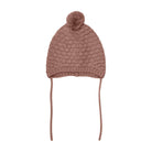 Knitted beanie with a pom-pom on a white background