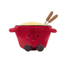 A red plush toy shaped like a smiling pot with two wooden chopsticks sticking out, shown on a plain white background.