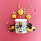 Jar of small round toys with a pink background