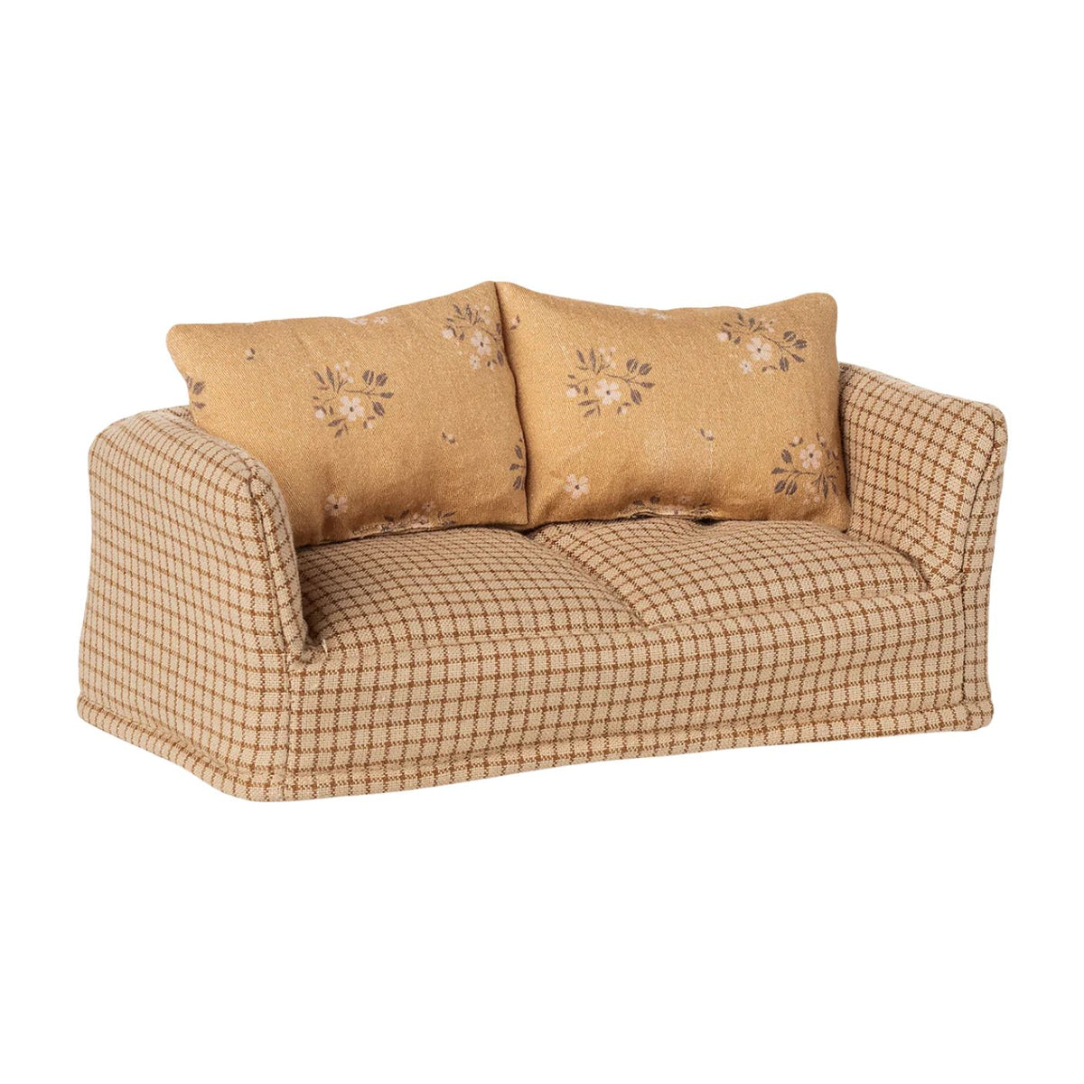 Beige checkered sofa with floral-patterned cushions on a white background