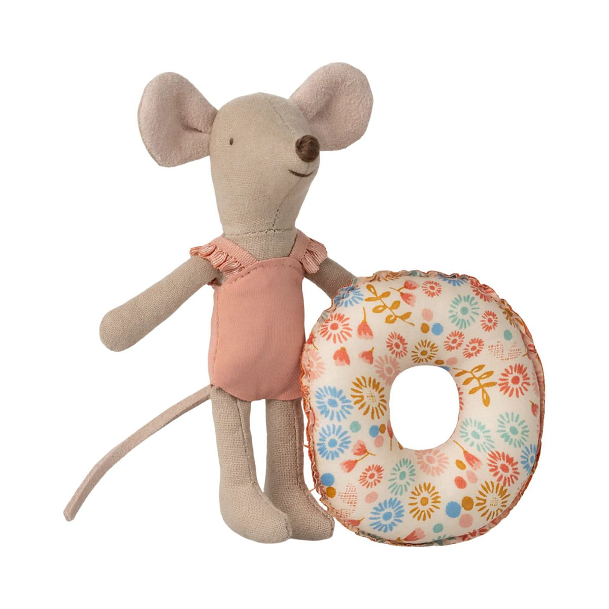A beige plush mouse toy wearing a dusty pink dress, standing next to a circular donut-shaped cushion with a colorful floral pattern on a white background.