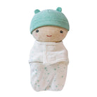 A baby swaddle blanket with an attached plush doll head wearing a mint green hat, shown on a plain white background.