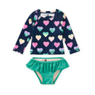 Children's swimsuit set with heart pattern top and green bottom on a white background