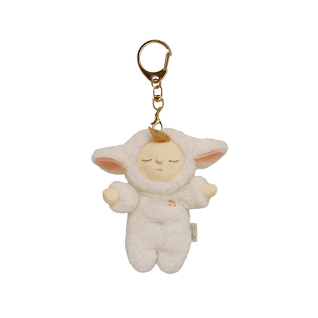A plush sheep keychain charm with a sleeping face, pink inner ears, and a small rainbow detail on its chest, attached to a gold metal key ring, shown on a plain white background.