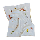 Baby blanket with alphabet and animal designs on a white background