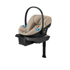 Beige baby car seat with black base on a white background