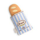 A bread-shaped teething toy or pet toy partially tucked into a blue-and-white striped fabric sleeve with an embroidered 'Bread' patch, shown on a clean white background.