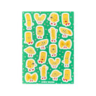 A sheet of pasta-shaped stickers featuring cartoon characters on a green background with small pink hearts. The brand name 'andrea bescia' is printed at the bottom.