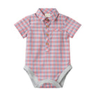 A baby short-sleeve bodysuit with a pink and light blue gingham check pattern, featuring a polo-style collar, three brown buttons, a chest pocket, and gray ribbed trim at the crotch and armholes.
