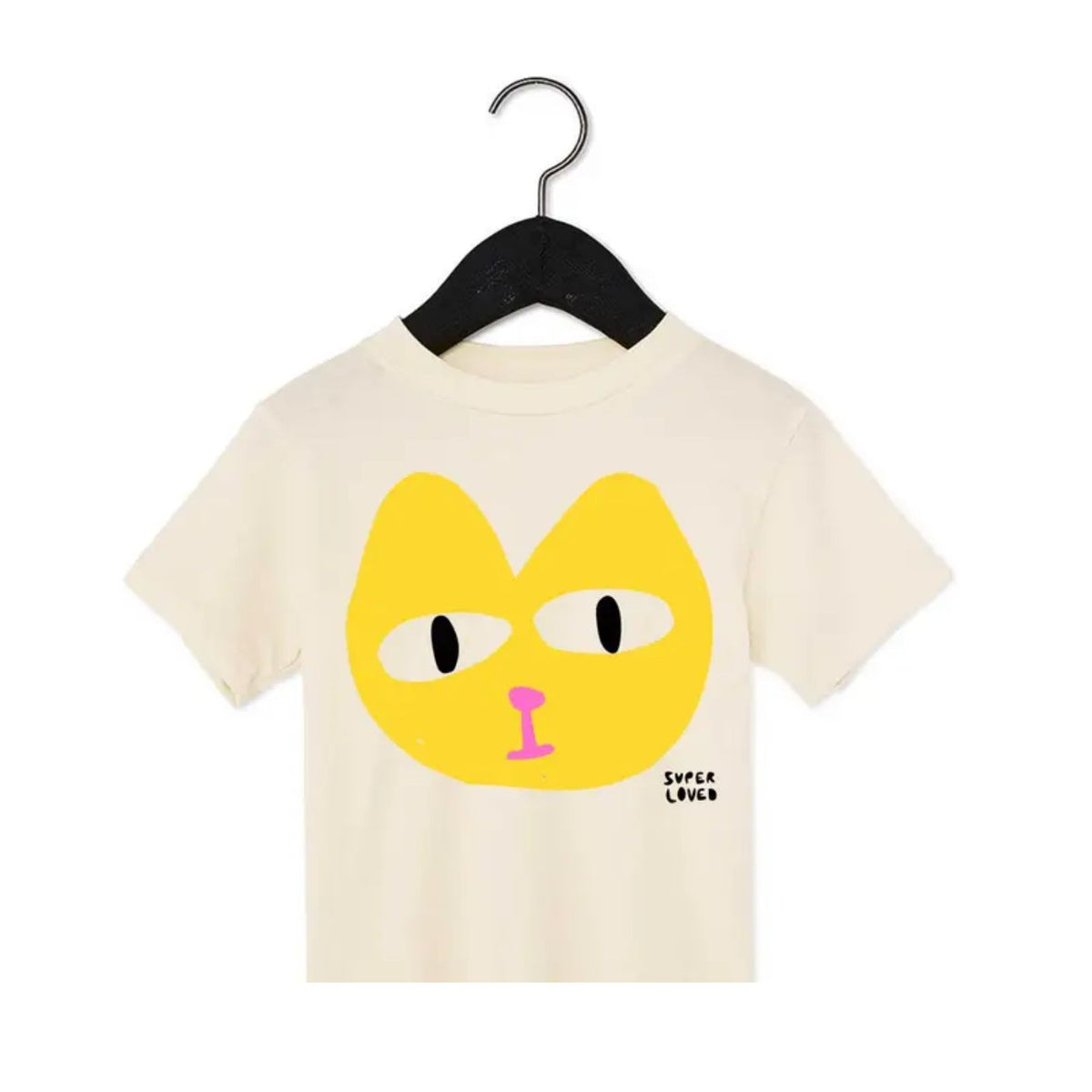 Beige t-shirt with a yellow cat face design on a hanger against a white background