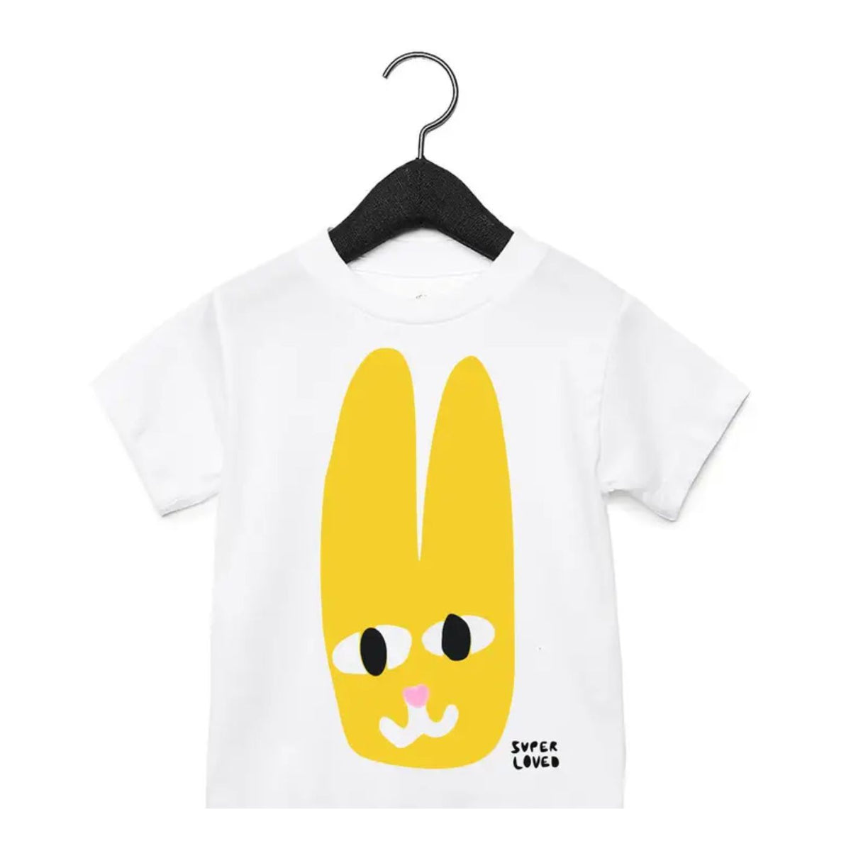 White t-shirt with a yellow cartoon character on a hanger against a white background