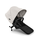 Baby stroller with beige canopy and black seat on a white background