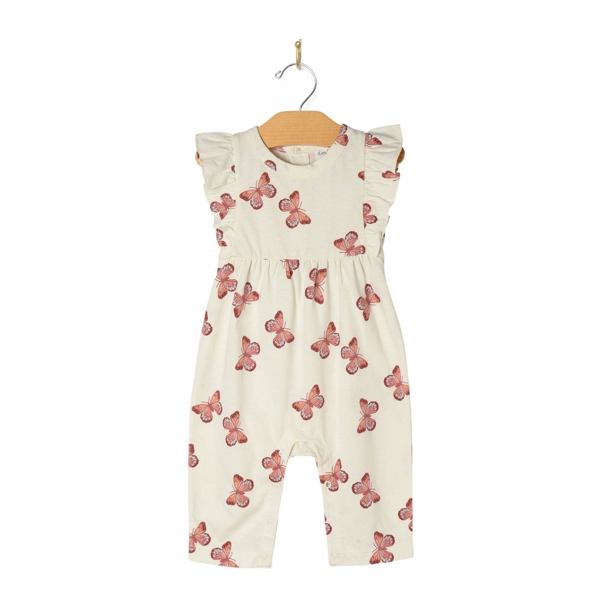 White romper with pink butterfly pattern on a hanger against a white background