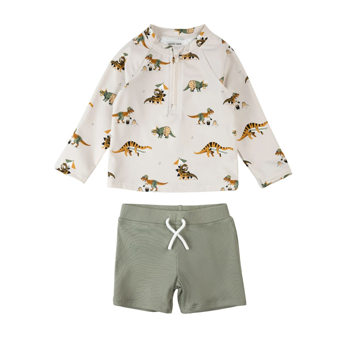A children's two-piece outfit set featuring a long-sleeve quarter-zip top with a cream background and a colorful dinosaur print, paired with olive green shorts with a white drawstring, shown on a plain white background.