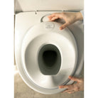 Baby potty seat being attached to a toilet with a hand visible.
