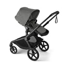 Gray and black stroller on a white background