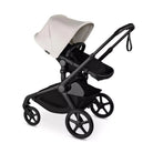 Black and beige baby stroller on a white background