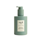 Green bottle of KYTE skin sensitive body lotion on a white background