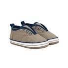 Pair of beige baby shoes with blue accents on a white background
