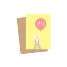 Greeting card with a rabbit and pink balloon on a yellow background, accompanied by a brown envelope.