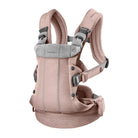 Baby carrier with pink mesh design and gray straps on a white background