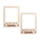 Two wooden frames with 'my last day of school' and 'my first day of school' text on a white background.