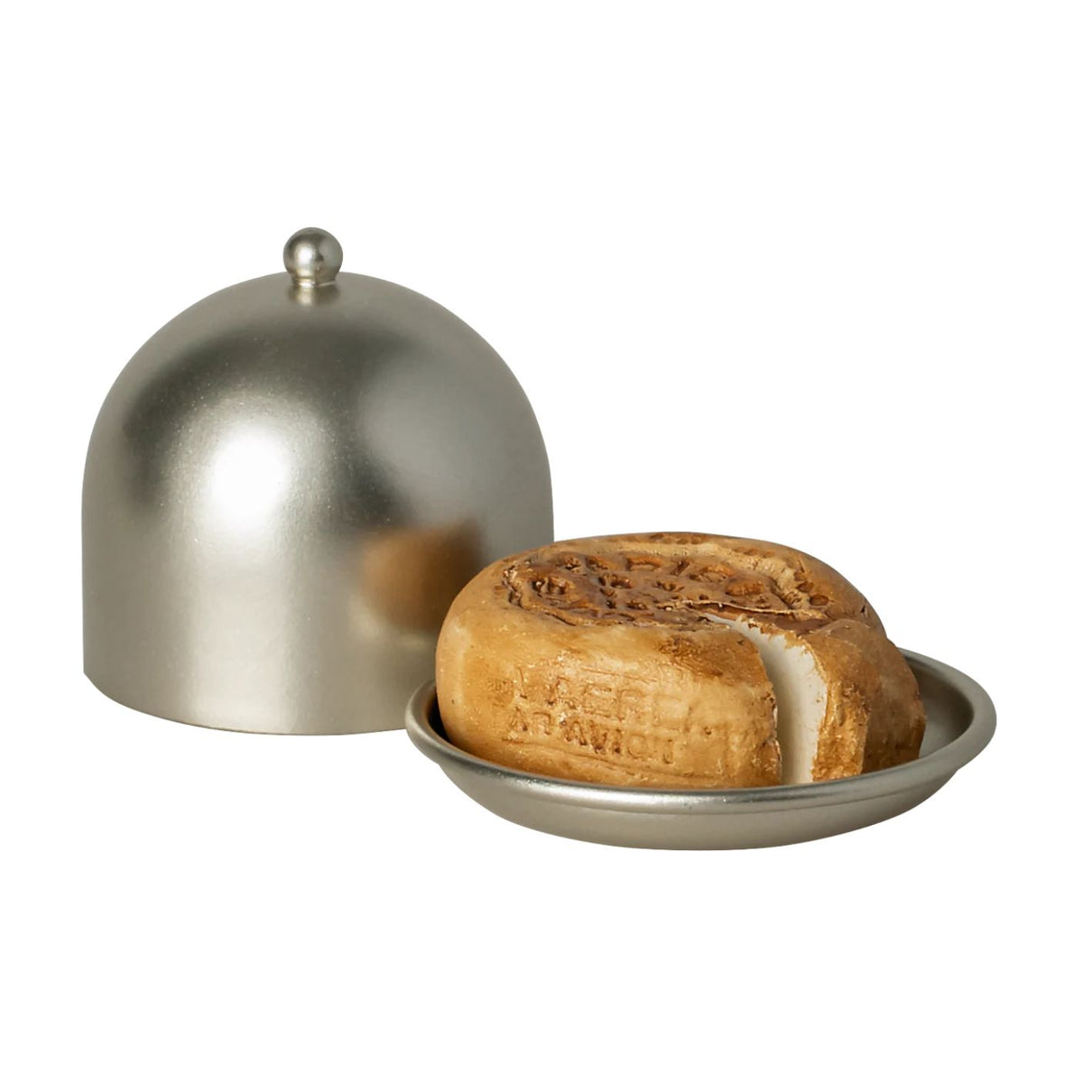 Round loaf of bread on a metal tray with a dome-shaped lid on a white background