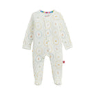 A baby footed sleeper in an off-white fabric with a colorful circular floral pattern, featuring long sleeves and a snap-button front closure.