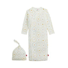 A baby sleep sack and matching knotted beanie set in a warm off-white fabric, both featuring a repeating pattern of small illustrated animals inside circular medallions outlined in yellow and light blue. The sleep sack has long sleeves and a snap-button closure, shown next to its matching hat on a solid white background.