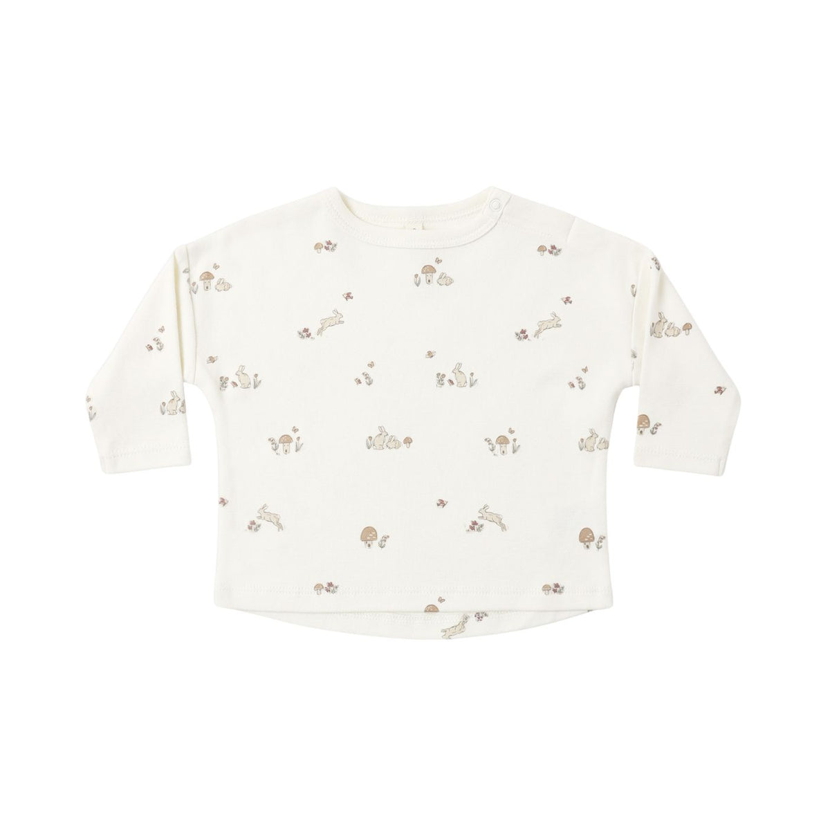 An off-white long-sleeve baby top with a delicate all-over print of small brown rabbits, flowers, and leaves, laid flat against a white background.