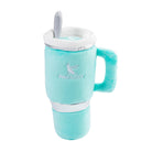 A plush Kentuckyucky brand cup-shaped dog toy in mint green with silver accents, a matching mint green treat tower, and a gray treat spoon, shown on a white background.