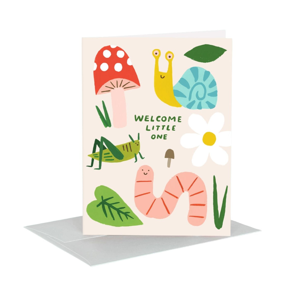 A children's greeting card with a light cream background and colorful illustrated nature motifs, including a red mushroom, yellow snail, blue shell, green grass, grasshopper, white flower, pink worm, and the text 'WELCOME LITTLE ONE'. A gray envelope is placed behind the card on a white background.