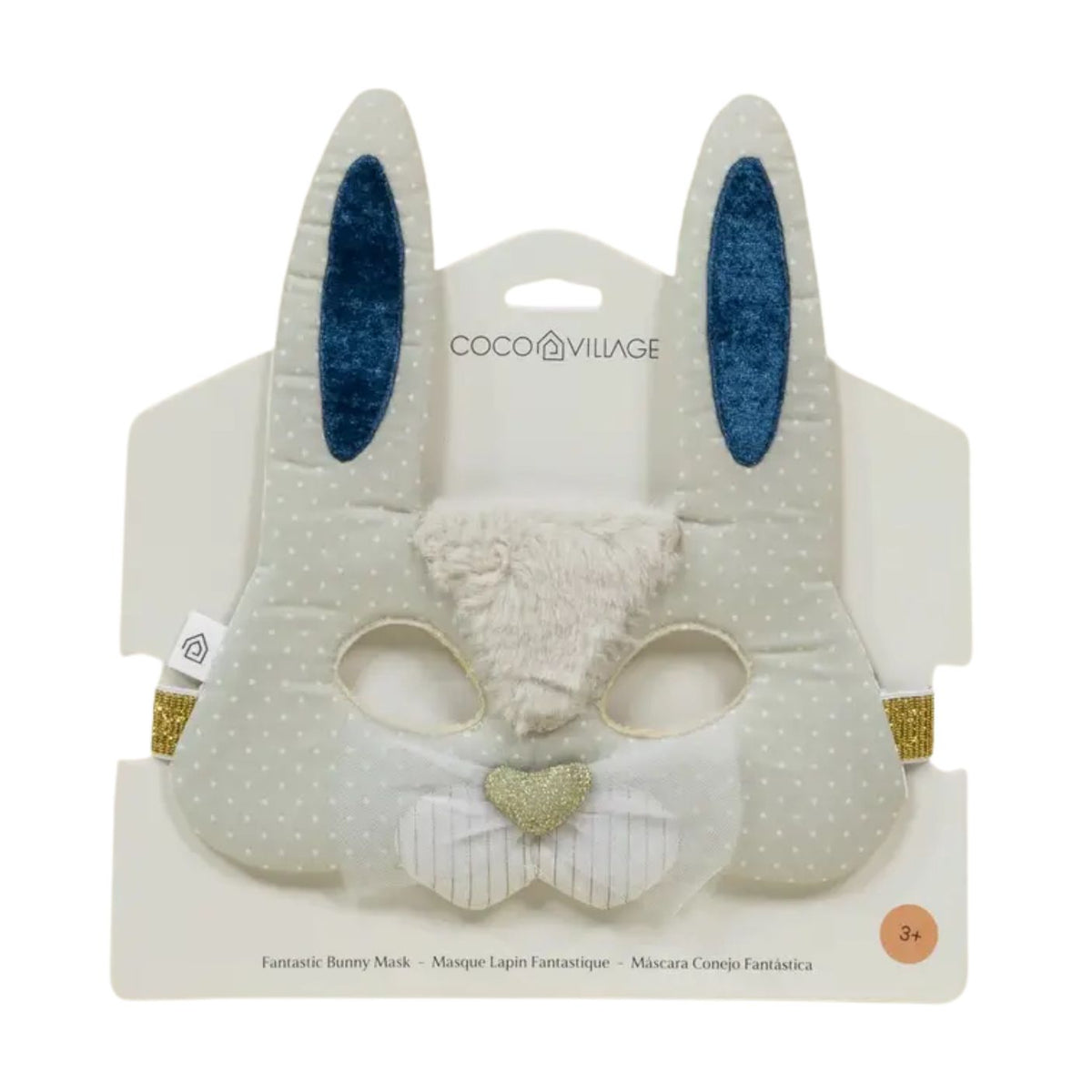 Coco Village Fantastic Bunny Mask in white with subtle polka dots, featuring blue glittery inner ears, a fluffy white faux-fur snout, and a small glittery gold heart on the nose, shown on its white retail backing card.