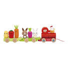 A wooden toy train set with a red locomotive and green passenger cars carrying cute animal and vegetable characters, photographed on a plain white background.