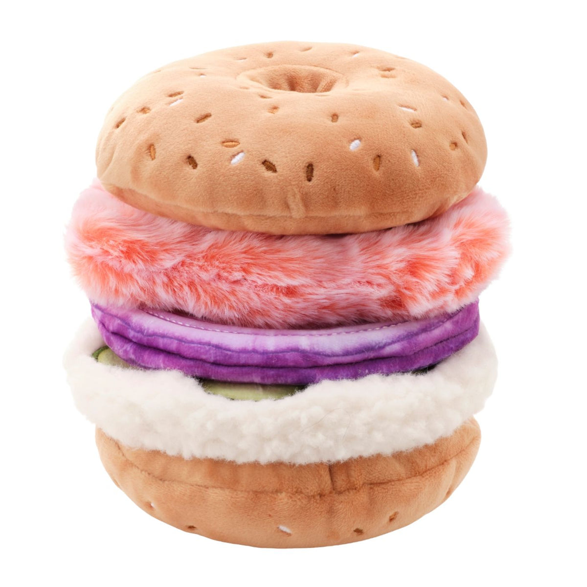 A plush toy shaped like a hamburger, featuring a tan sesame seed bun top and bottom, a fuzzy pinkish-red patty, purple onion layers, white cheese, and green pickle slices, isolated on a white background.