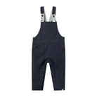 A pair of dark navy blue denim baby overalls with adjustable suspenders, front patch pocket, and side button closures, shown flat on a white background.