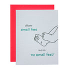 A square greeting card with a bright red envelope behind it. The card has a textured off-white surface with a simple black line drawing of baby feet and teal text reading 'those small feet were no small feat!'.