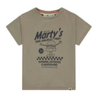 A kids' short-sleeve t-shirt in a muted taupe-beige color, featuring a dark gray graphic print of a cartoon burger and the text 'Marty's'.