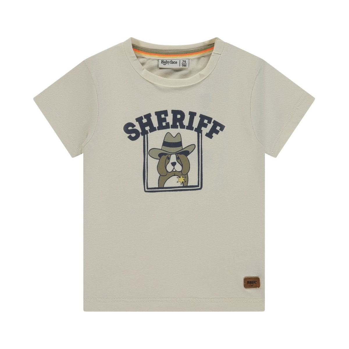 A light beige short-sleeve t-shirt with a 'SHERIFF' graphic featuring a cartoon dog in a cowboy hat. The brand name 'Right-Brown' is visible on the inner neck label and as a small brown patch on the lower right hem.