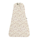 A baby sleep sack with a light beige background and a delicate dusty pink floral pattern, featuring a front zipper.
