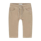 A pair of beige ribbed knit pants for toddlers, featuring an elastic waistband with a matching drawstring, side pockets, and a straight leg cut, shown against a plain white background.