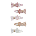 Five hair claw clips with bow details in soft pink, dusty rose, pale pink, champagne beige, and white, arranged vertically on a plain white background.
