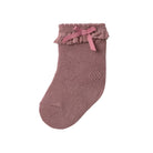 A single dusty rose knit baby sock with a ruffled trim and a matching pink ribbon bow at the top, shown against a plain white background.
