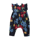 A baby romper with a dark navy blue background and a colorful floral print featuring red, blue, yellow, and green flowers, shown against a plain white background.