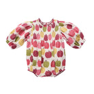 A baby smocked romper with puff sleeves, featuring an all-over apple print in red, green, and yellow on a cream background, shown flat on a white background.