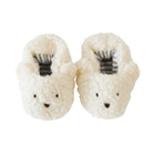 Pair of white fuzzy slippers with black accents on a white background