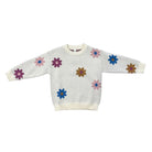 A white long-sleeve knit sweater with colorful knit flower motifs in pink, purple, blue, and brown, displayed flat against a white background.