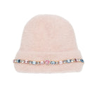 A light pink fuzzy beanie hat featuring a decorative band of colorful rhinestones and a central pink gemstone on the front, set against a plain white background.